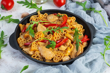 Tasty pasta in tomato sauce with chicken, pepper and herbs on white background