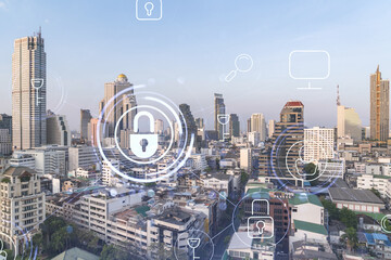 Padlock icon hologram over panorama city view of Bangkok to protect business in Southeast Asia. The concept of information security shields. Double exposure.
