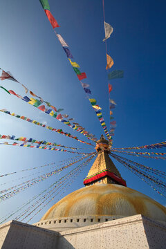 Nepal, Bagmati Province, Kathmandu, Prayer flags hanging from top of Boudhanath stupa