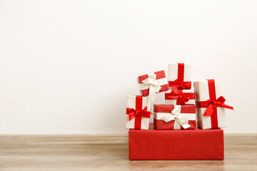 Christmas preparation concept. Stack of different colorful red and white presents for every family...