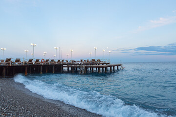 Fototapeta premium wooden sea pier with sun loungers