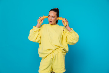 a beautiful woman holds a banana in her ears