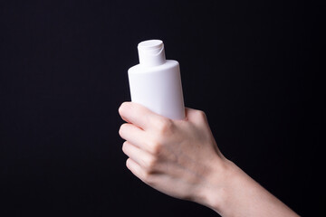 packaging of lotion or hand cream in female hands