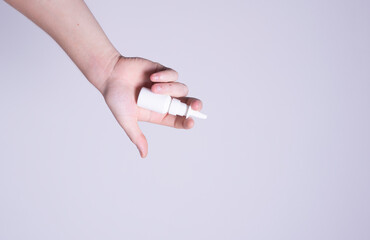 male hand holding nose spray
