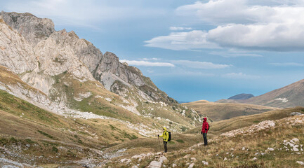 Fototapeta premium Two active tourists traveling in mountains. Lago-Naki Plateau in Russia