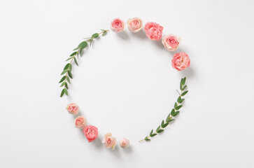 Beautiful wreath made of rose flowers and eucalyptus on white background, flat lay