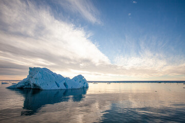 Fototapeta na wymiar Broken off glacial ice floats in the arctic sea