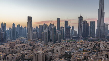 Dubai's business bay towers aerial day to night timelapse. Rooftop view of some skyscrapers