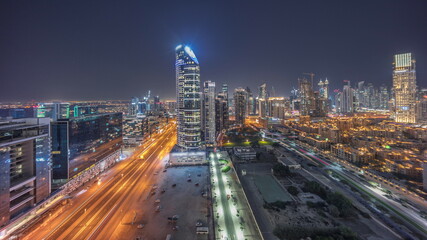 Obraz na płótnie Canvas Dubai's business bay towers aerial night timelapse. Rooftop view of some skyscrapers