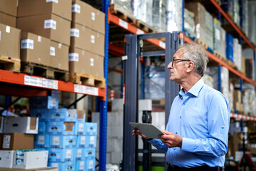 Caucasian leader in mature age checking the ware on the rack