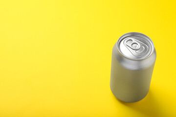 Can of energy drink on yellow background. Space for text