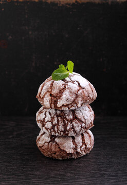 Cookies "chocolate cracks" decorated with mint on a black background