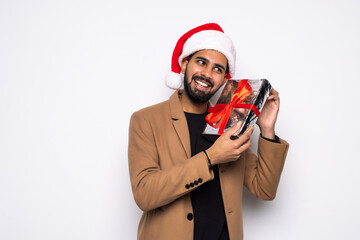 Handsome man holding gifts on white background