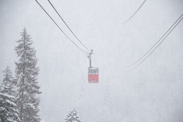 red skilift cabine in the strong snowfall in the mountains of the Caucasus