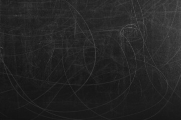 Texture of scratched black surface as background, closeup