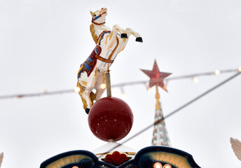 Moscow, Russia, December 7, 2021: Christmas market with New Year Tree and retro carousel horse on Red Square, between GUM and Kremlin decorated and illuminated. Red Square. 