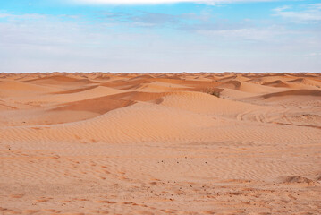 Fototapeta na wymiar Desert sand dunes on distance in the Sahara in Tunisia.