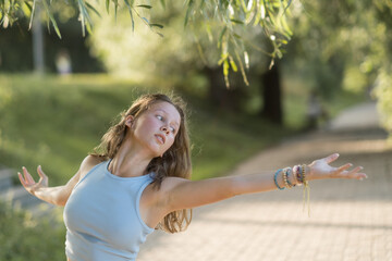 Girl dancing modern choreography in the park