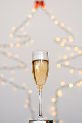 A glass of wine, champagne with envelope against bokeh background close up. Top view. New Year, Christmas mood. Greeting card. Party and holiday celebration concept.