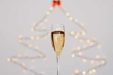 A glass of wine, champagne with envelope against bokeh background close up. Top view. New Year, Christmas mood. Greeting card. Party and holiday celebration concept.