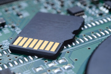 the black micro sd card lies on the microcircuit. close-up.