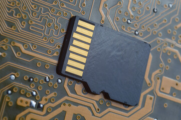 the black micro sd card lies on the microcircuit. close-up.