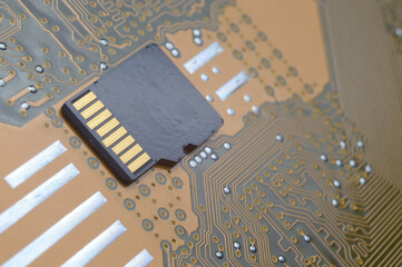 the black micro sd card lies on the microcircuit. close-up.