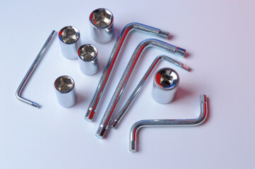 chrome plated locksmith tools, hexagons and socket heads.  lie on a white background.