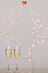 Two glasses of wine with bokeh background close up. Top view. New Year, Christmas mood. Greeting card. Party and holiday celebration concept.