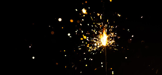 New year sparkler candle isolated on black background