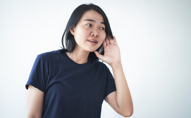 Young asian woman holding her ear to listen