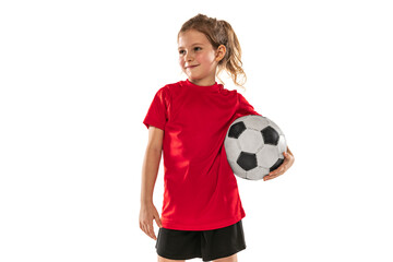 Cropped portrait of girl, child, football player in red uniform training, posing isolated over...