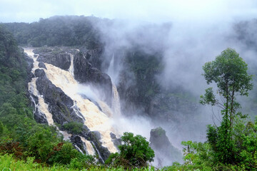 Waterfall in the fog. The Barron Falls (Aboriginal: Din Din) is a steeply tierred cascade waterfall on the Barron River in Cairns, Queensland, Australia.