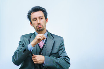 businessman with tousled hair looks at the camera surprised and holds glasses