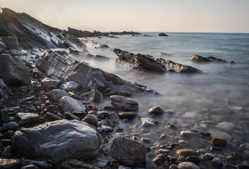 Ocean in France with a calm weather and rocks.