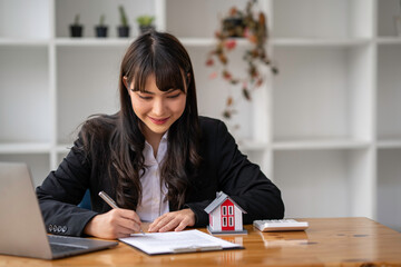 Portrait of a real estate agent Or the buyer is signing a contract to buy or sell a house, signing a contract, signing concept.