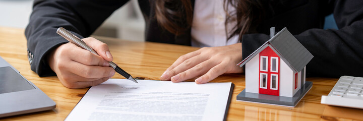 real estate agent Or the buyer is signing a contract to buy or sell a house, signing a contract,...
