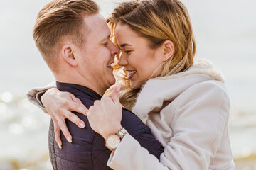 Young loving couple spending time together at spring beach.Blur background,close up.