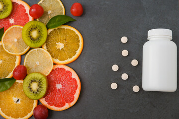 Vitamins. White empty bottle for vitamins on a background of citrus fruit slices. Pills. lemon....