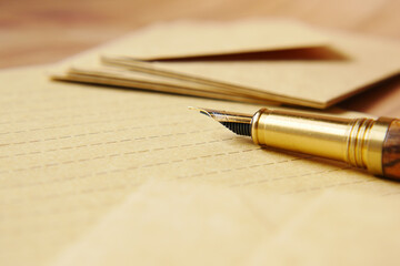 envelope , empty paper and fountain pen on table 