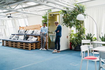 Male professional team using digital tablet in office