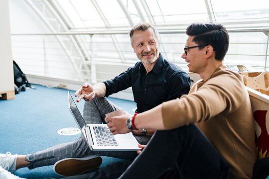 Creative businessman having discussion with colleague in office