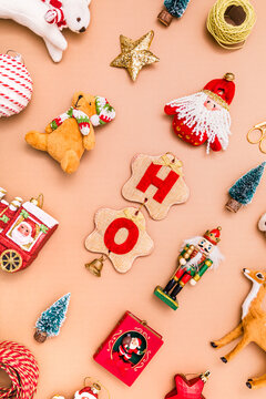 Collection of various Christmas decorations flat laid against beige background