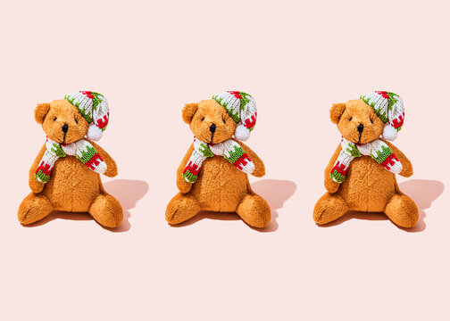 Studio shot of three anthropomorphic teddy bears wearing scarfs and knit hats