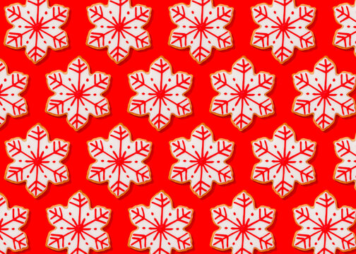 Pattern of snowflake shaped Christmas cookies flat laid against vibrant red background