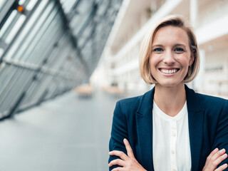 Blond businesswoman smiling in office