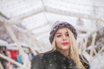 lovely lady walking at the holiday fair during snow