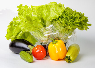 Set of fresh raw vegetables on a white background. Salad, tomatoes, cucumbers, eggplants, zucchini