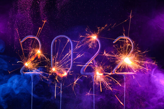 2022 Happy new year card with with sparklers shiny glitter and colorful smoke
