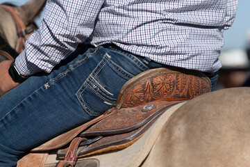 A man siting on a horse saddle in Arizona